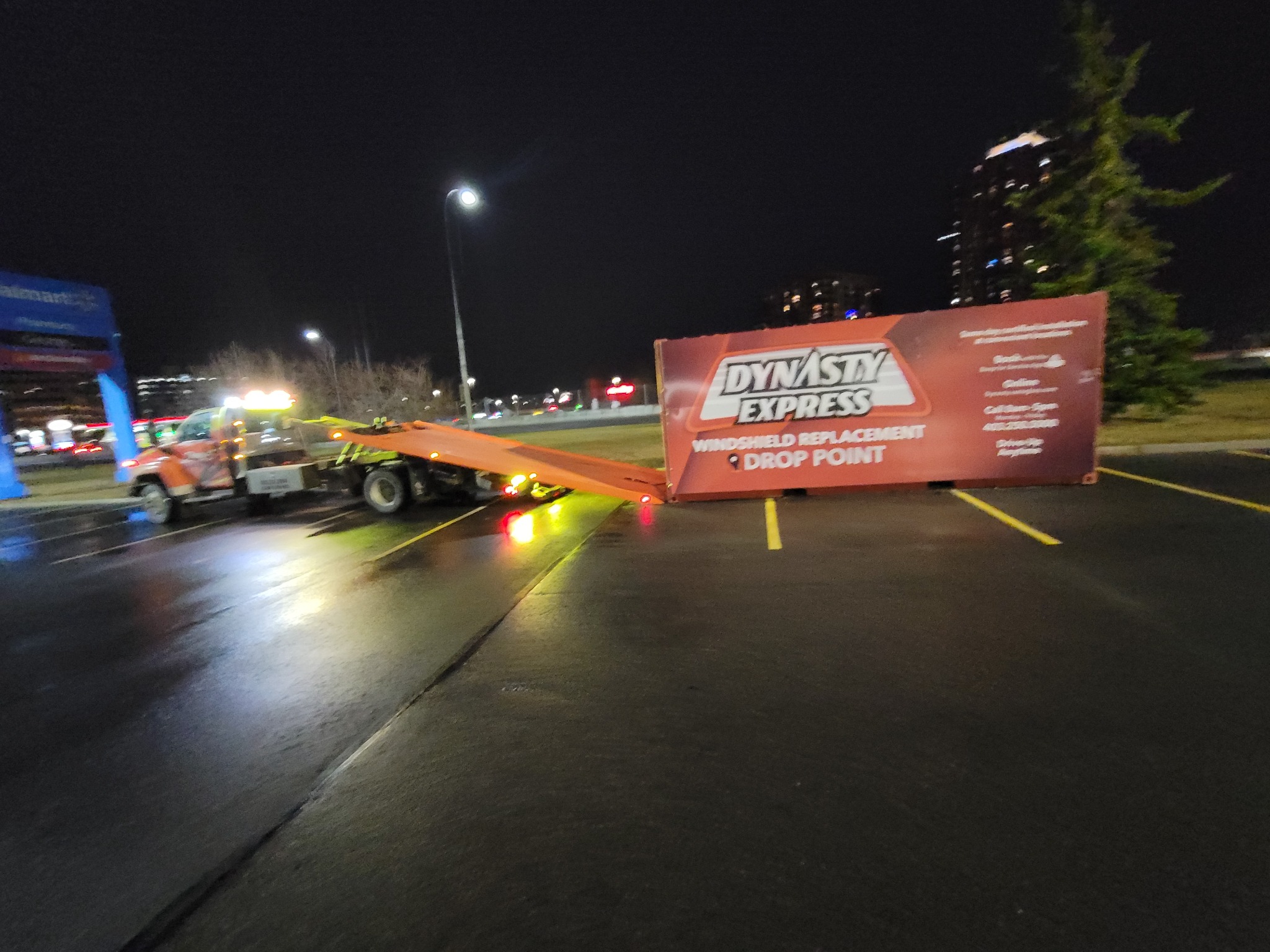 Night recovery with flatbed in Calgary parking lot