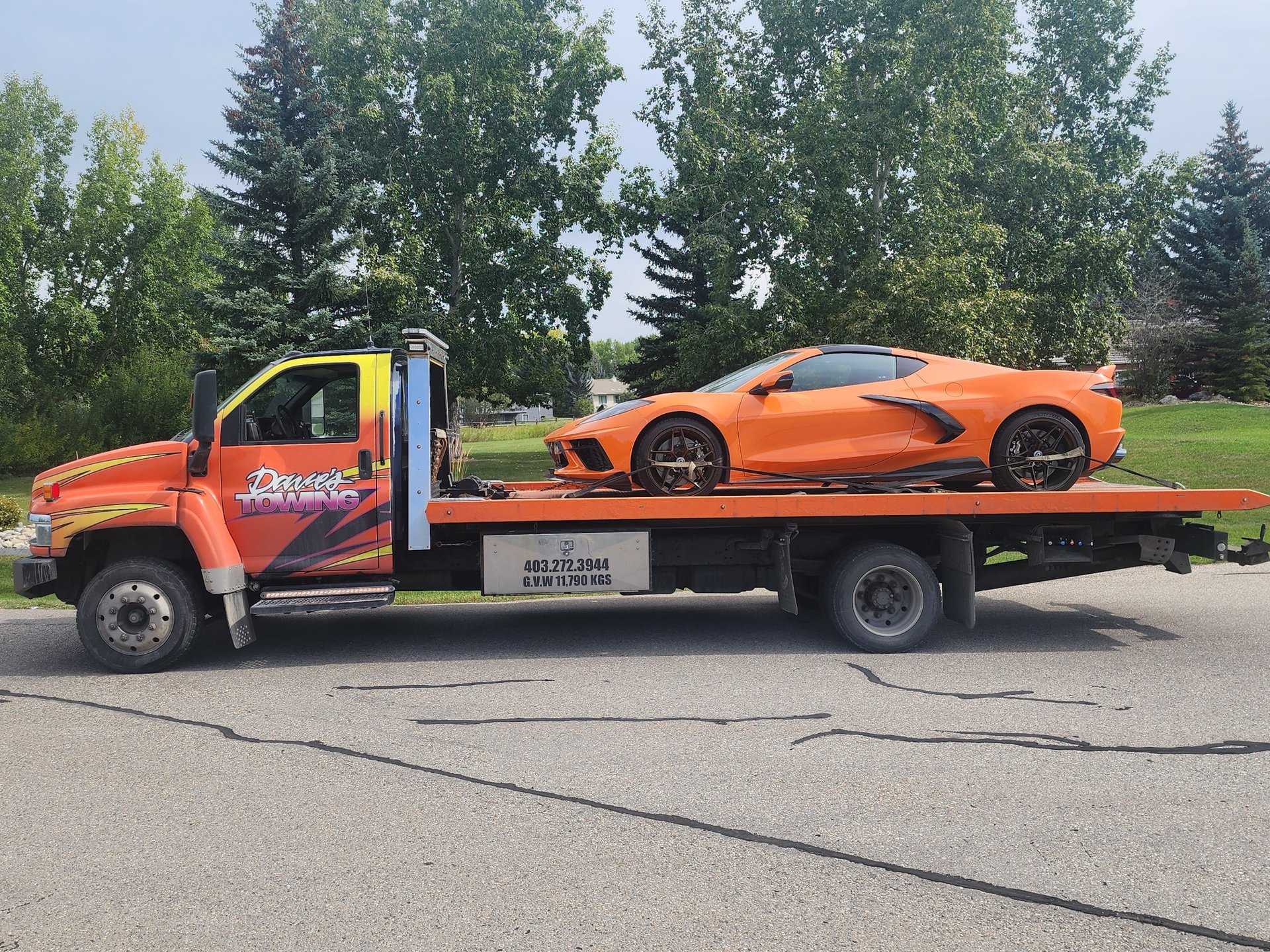 Dave's Towing flatbed truck towing a sports car in Calgary