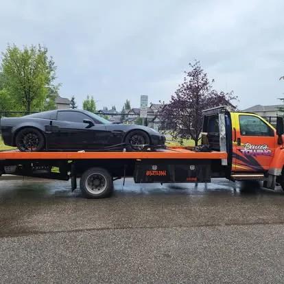 Dave's Towing: Black Corvette Flatbed Transport in Calgary