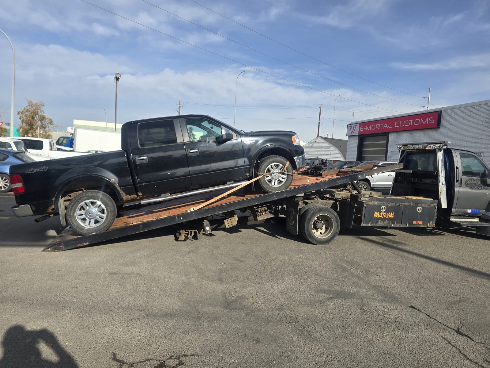 Dave's Towing: Black Ford F-150 Flatbed Tow in Calgary